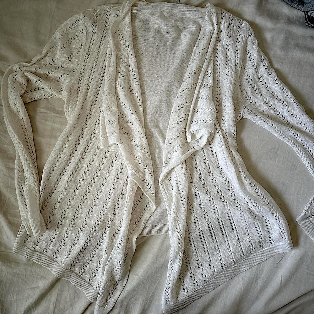 white cardigan with beautiful details and asymmetrical hem
brand: est. 1946